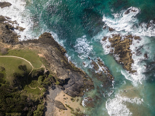 An australian beach as vied from above with cliffs and rock faces
