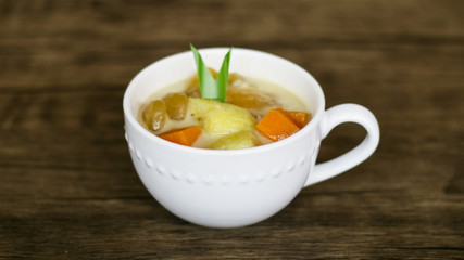 Indonesian sweet desserts or kolak on wood background. 