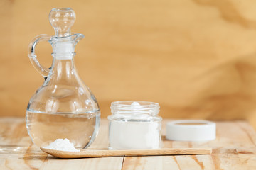 baking soda - sodium bicarbonate and vinegar, on wooden background