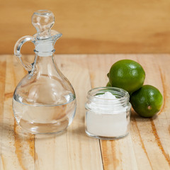 baking soda - sodium bicarbonate lemon and vinegar, on wooden background