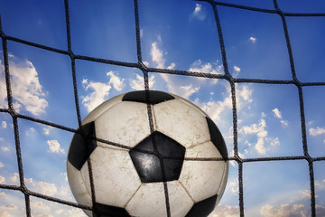 net and soccer ball on the background of a sky