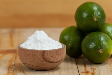 baking soda - sodium bicarbonate and lemon, on wooden background