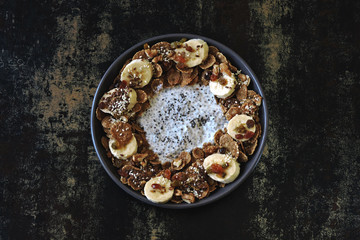 Stylish and healthy breakfast bowl. Flat Lay. Healthy breakfast with yogurt, chia seeds, cereal, banana.