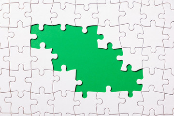 Jigsaw puzzle game piece on green background for business theme design