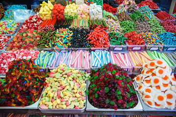Close up view of assorted colorful jelly gummy candies on outdoors market.