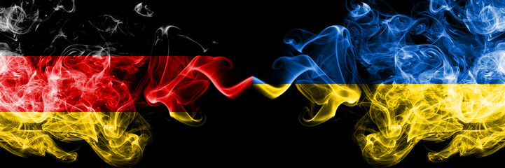 Germany vs Ukraine, Ukrainian smoky mystic flags placed side by side. Thick colored silky smoke flags of Deutschland and Ukraine, Ukrainian