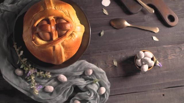 Easter folar with egg on wooden table top.