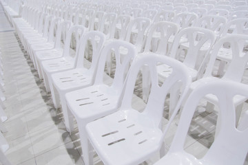 Many white chairs are beautifully arranged.