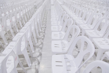 Many white chairs are beautifully arranged.