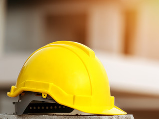 Yellow hard safety wear helmet hat in the project in construction site