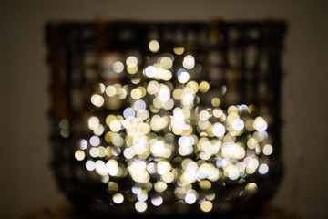 Decorative colored fairy lights blurred with bokeh, on display in a basket