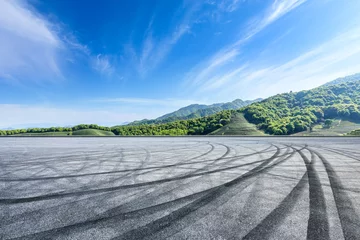 Fotobehang Formule 1 Empty asphalt race track and beautiful natural landscape  © ABCDstock
