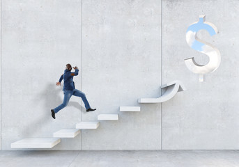Black businessman climbing stone stairs illustrating career development and success concept. Mixed...