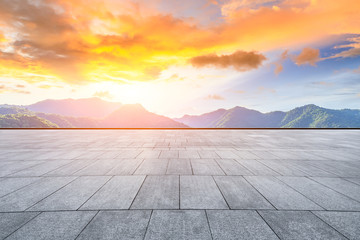 Empty square floor and green mountain natural landscape at sunset