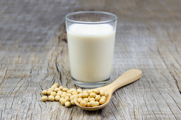 soy milk with soybean on wooden background.