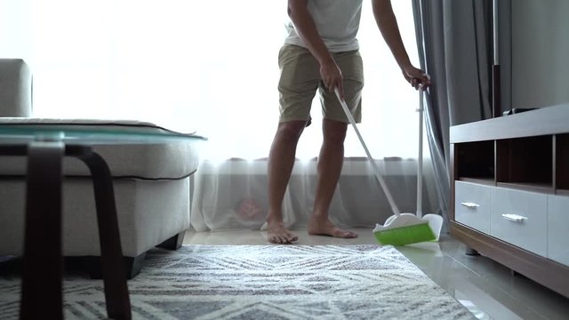housekeeper is sweeping the floor during the day