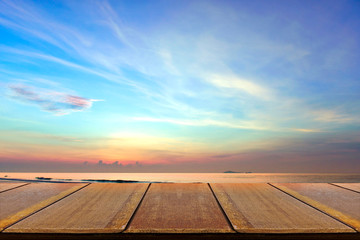 Wood table wth sunrise background, early morning light.