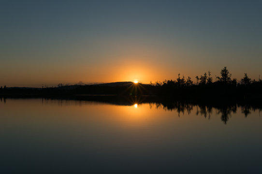 Calm and quite nature landscape on sunset with still water © Olga K