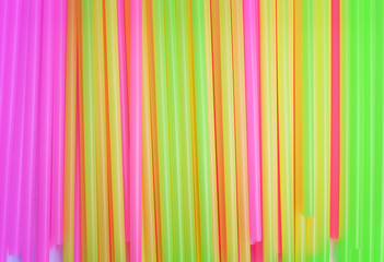 Obraz premium Top view colorful green , pink and yellow drinking straw background