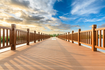 Boardwalk and beautiful clouds in city park