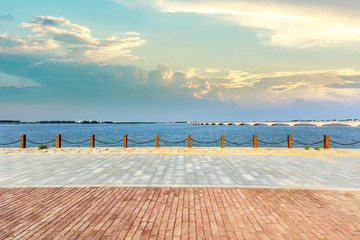 Beautiful lake and walkway with sky clouds at sunset