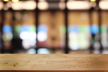 Empty dark wooden table in front of abstract blurred bokeh background of restaurant . can be used for display or montage your products.Mock up for space.