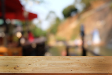 Empty dark wooden table in front of abstract blurred bokeh background of restaurant . can be used for display or montage your products.Mock up for space.