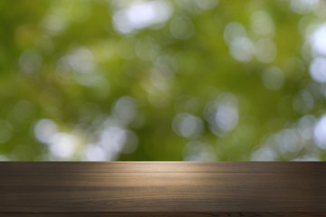 Empty dark wooden table in front of abstract blurred bokeh background of restaurant . can be used for display or montage your products.Mock up for space.