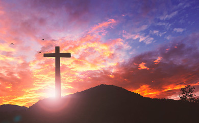 Silhouette the cross on sunset background