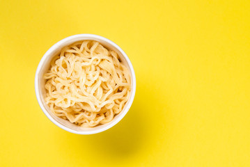 Cooked instant noodles with yellow background
