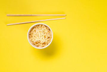 Cooked instant noodles with yellow background