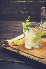Old fashioned beverage with lime and mint leaves. Selective focus. Shallow depth of field.