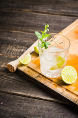 Old fashioned beverage with lime and mint leaves. Selective focus. Shallow depth of field.