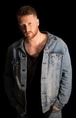 handsome man with beard and hands in pockets is watching you