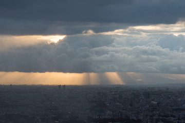 Aerial of Tokyo suburb cityscape with picturesque clouds and sunrays at sunset