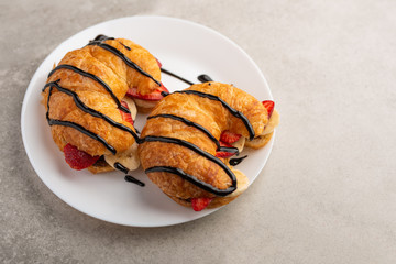 Breakfast with croissant, bananas and strawberries. with chocolate, with space