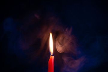 Candle fire with smoke, blue and orange gradient texture on a black background. Flame and colored smoke graphics