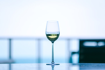 Closeup image of champagne in a wine glass with blurred background