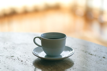 A white mug of hot coffee on the table