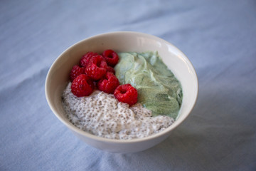 Chia pudding with spirulina yogurt and raspberry