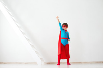 Obraz na płótnie Canvas Boy dreamer in costume and pose superhero.
