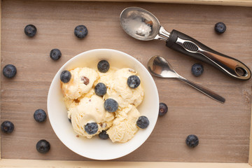 ice cream with blueberries, on a white background with a spoon. on a tray, summer mood