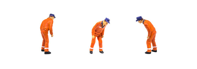 Miniature figurine character as construction worker standing and working in posture isolated on white background.