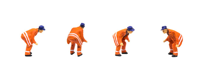 Miniature figurine character as construction worker standing and working in posture isolated on...