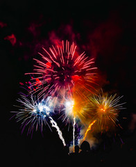 Crowd watching fireworks on black background