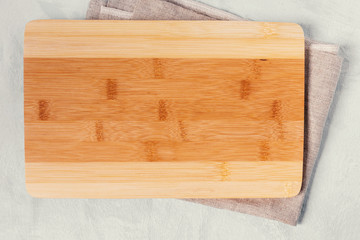 Kitchen cutting Board made of bamboo and napkin on the table.