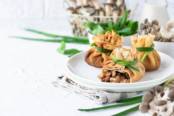Pancake bags stuffed with with fried oyster mushrooms with spinach
