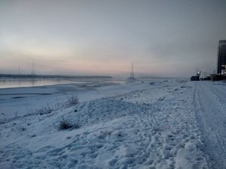 Fototapeta na wymiar winter landscape with frozen river and blue sky