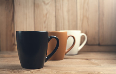 Coffee cups on wood background.