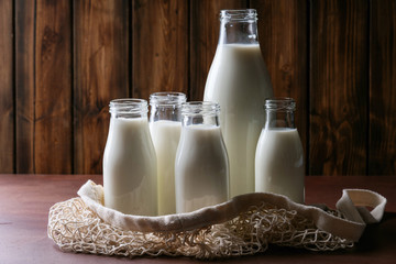 Fresh milk in different glass bottles